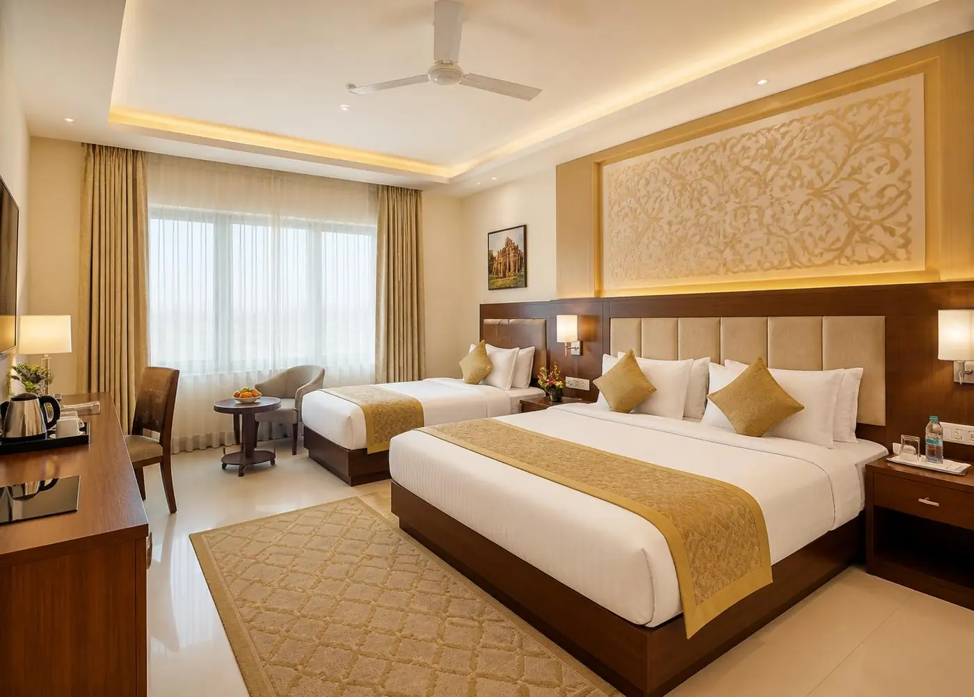 Spacious family room with a double bed and extra single bed in gold tones
